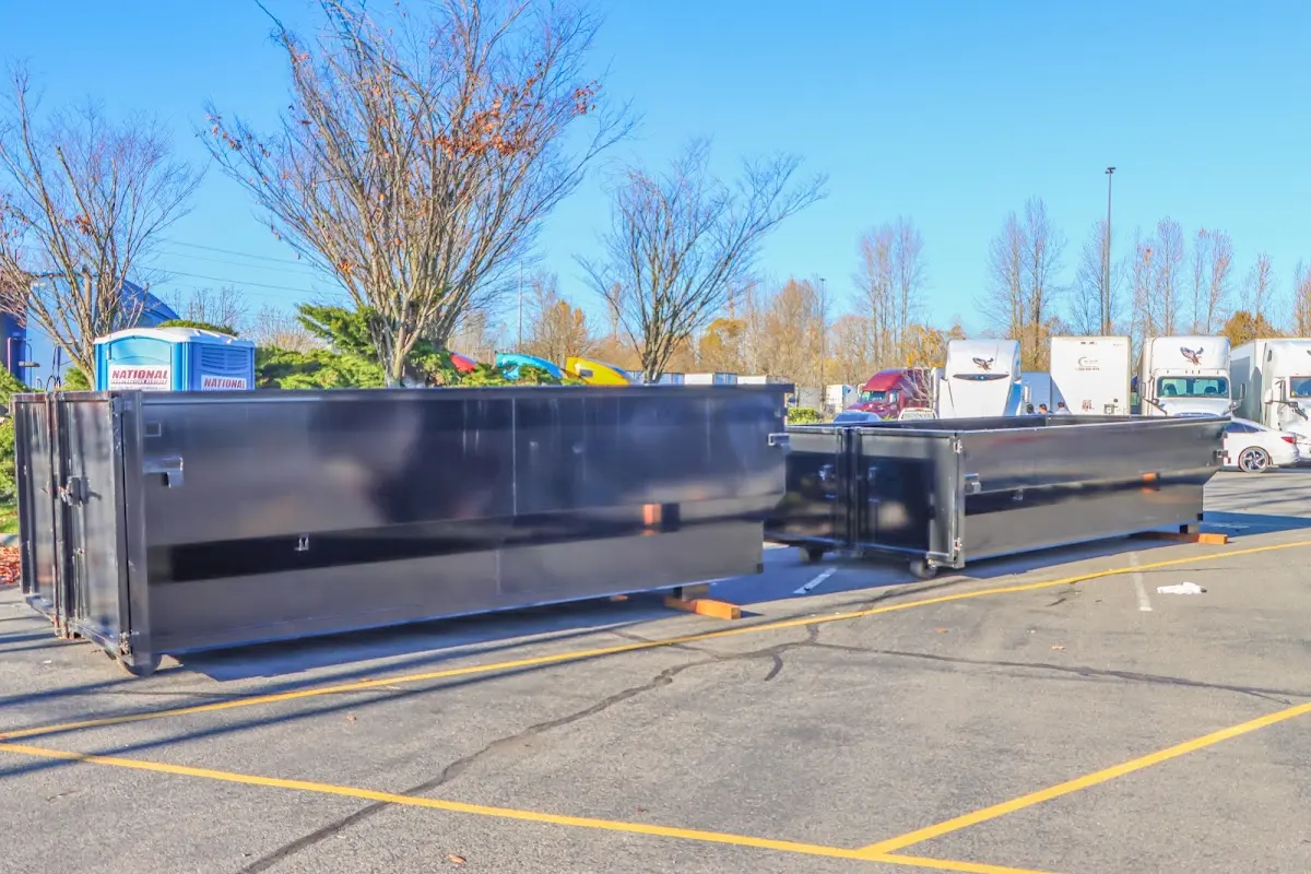 Professional dumpster rental service with roll-off container on residential driveway in Immokalee